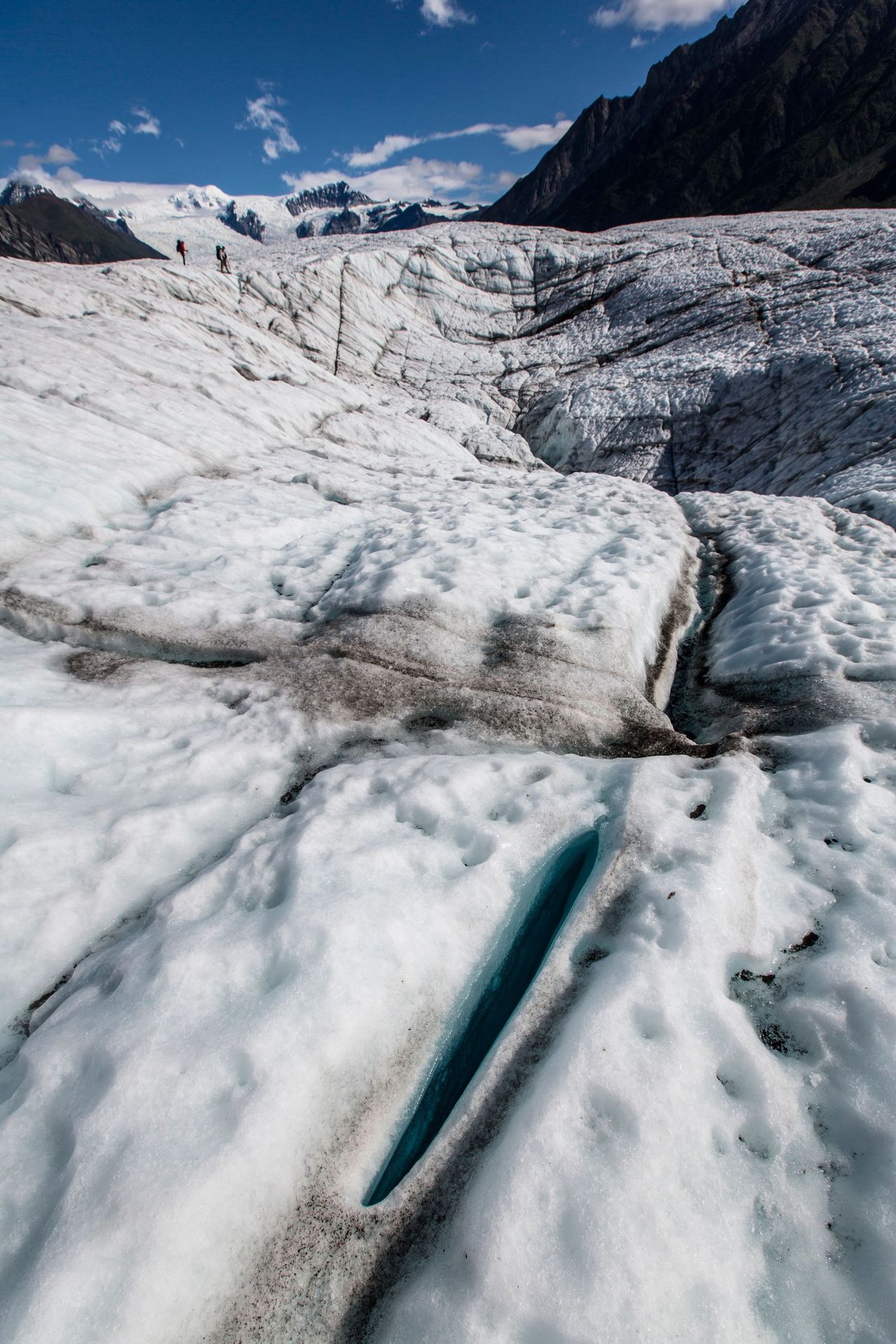 Meltwater crevasse with turquoise ice in a glacier in Alaska