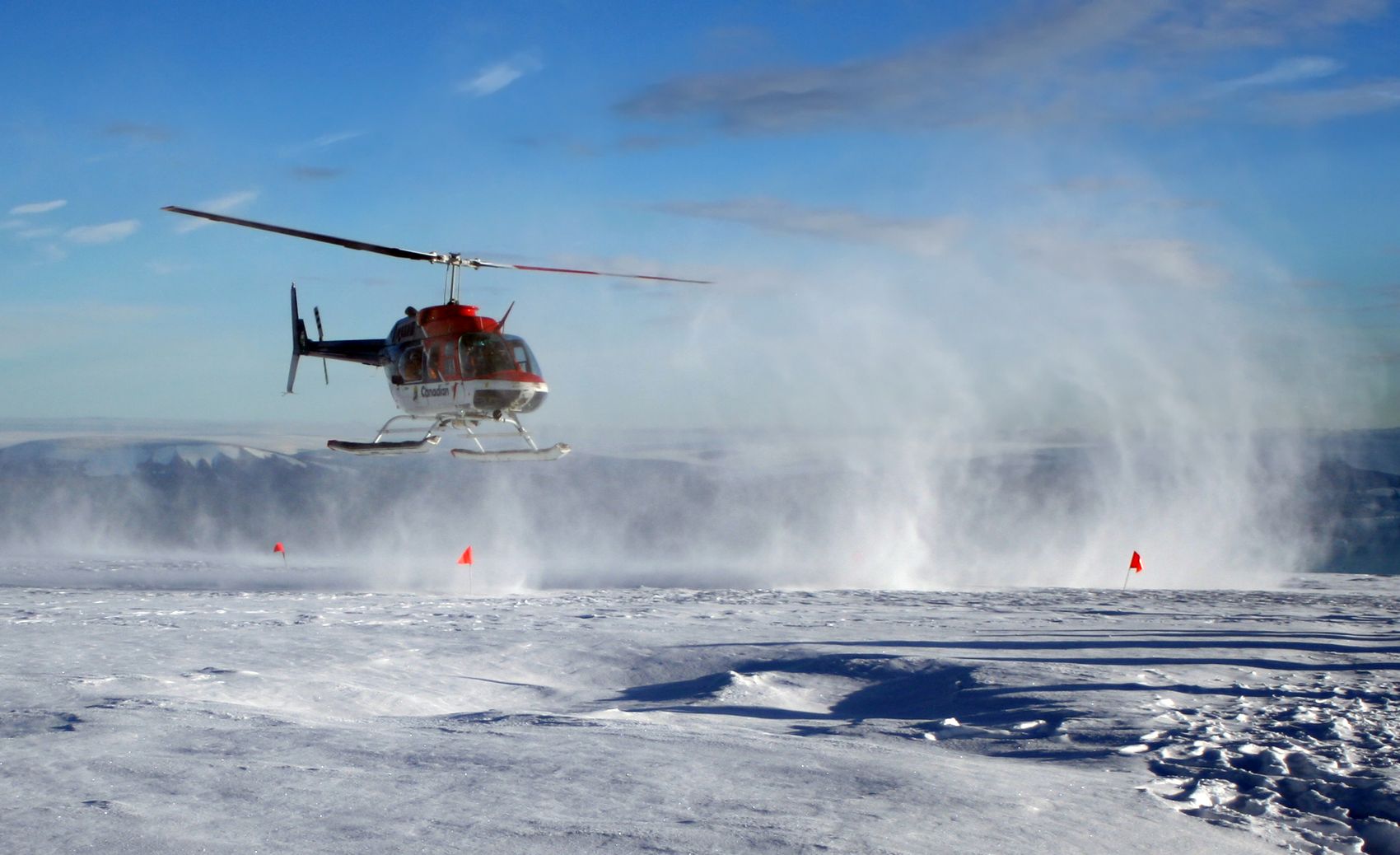 Helicopter taking off from the ice sheet in Greenland