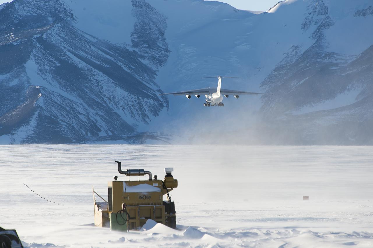Transport aircraft landing on the ice runway in Antarctica