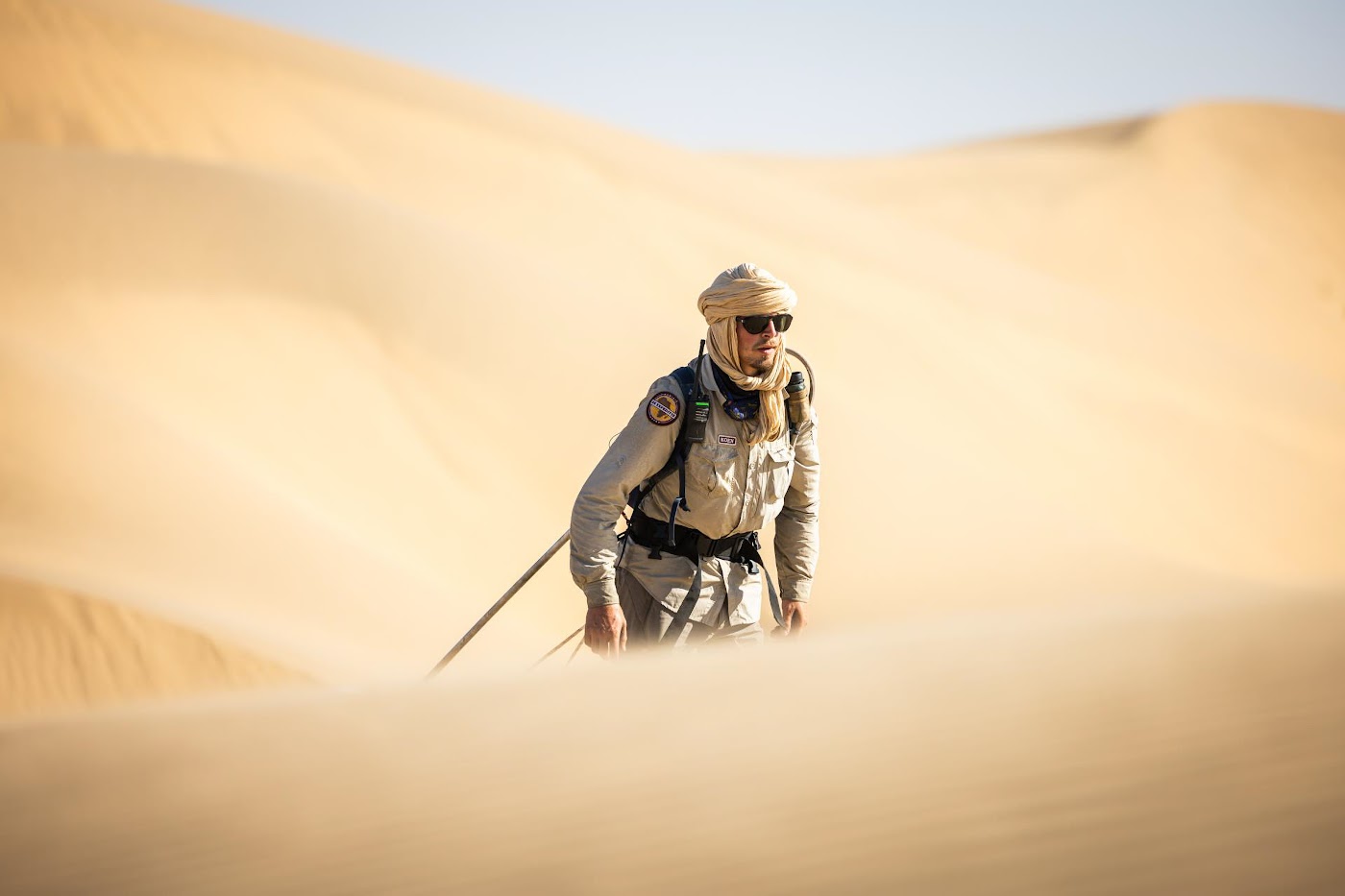 Participant walking alone through the dunes on an Element X expedition