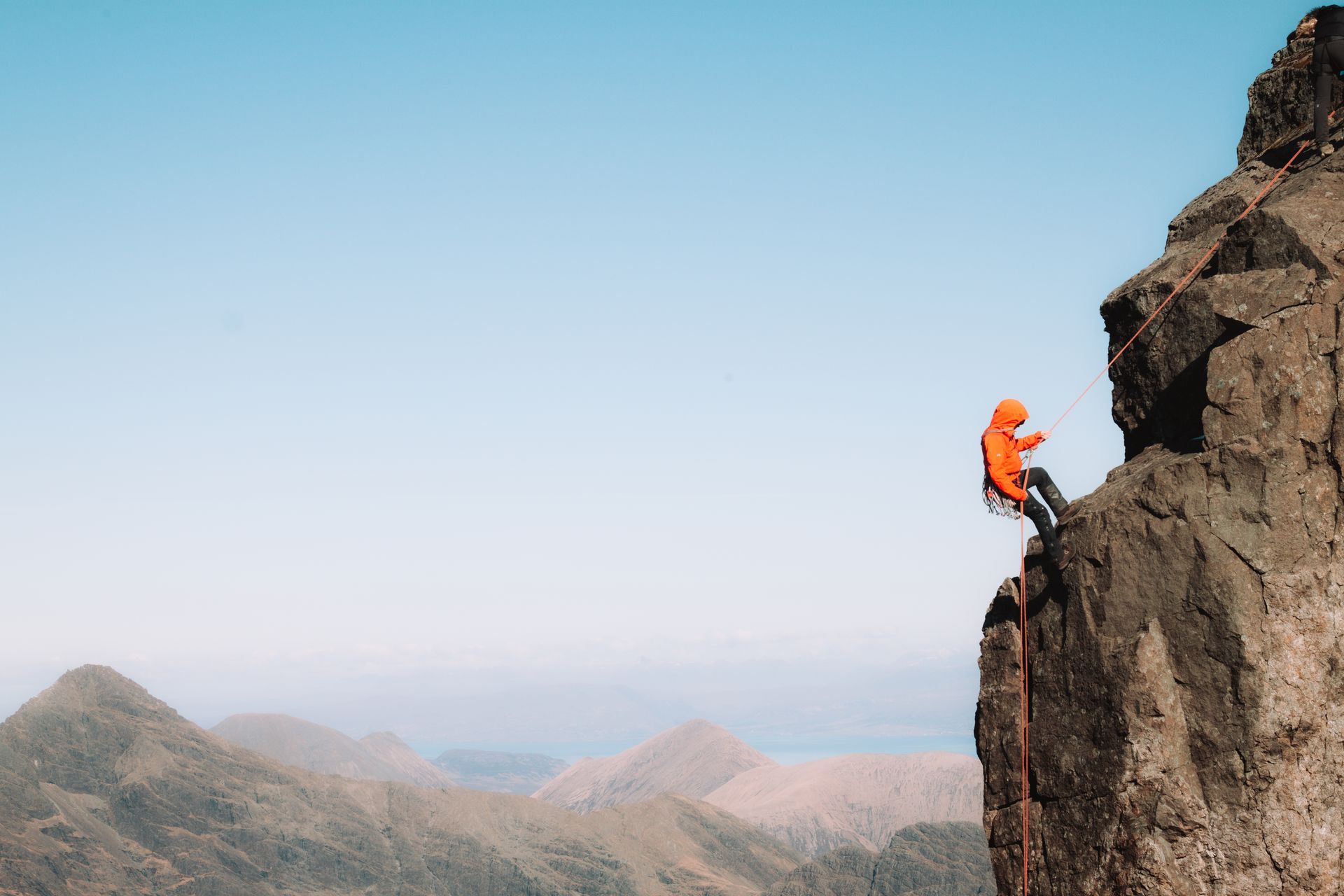 An X Guide belaying a participant on a technical passage