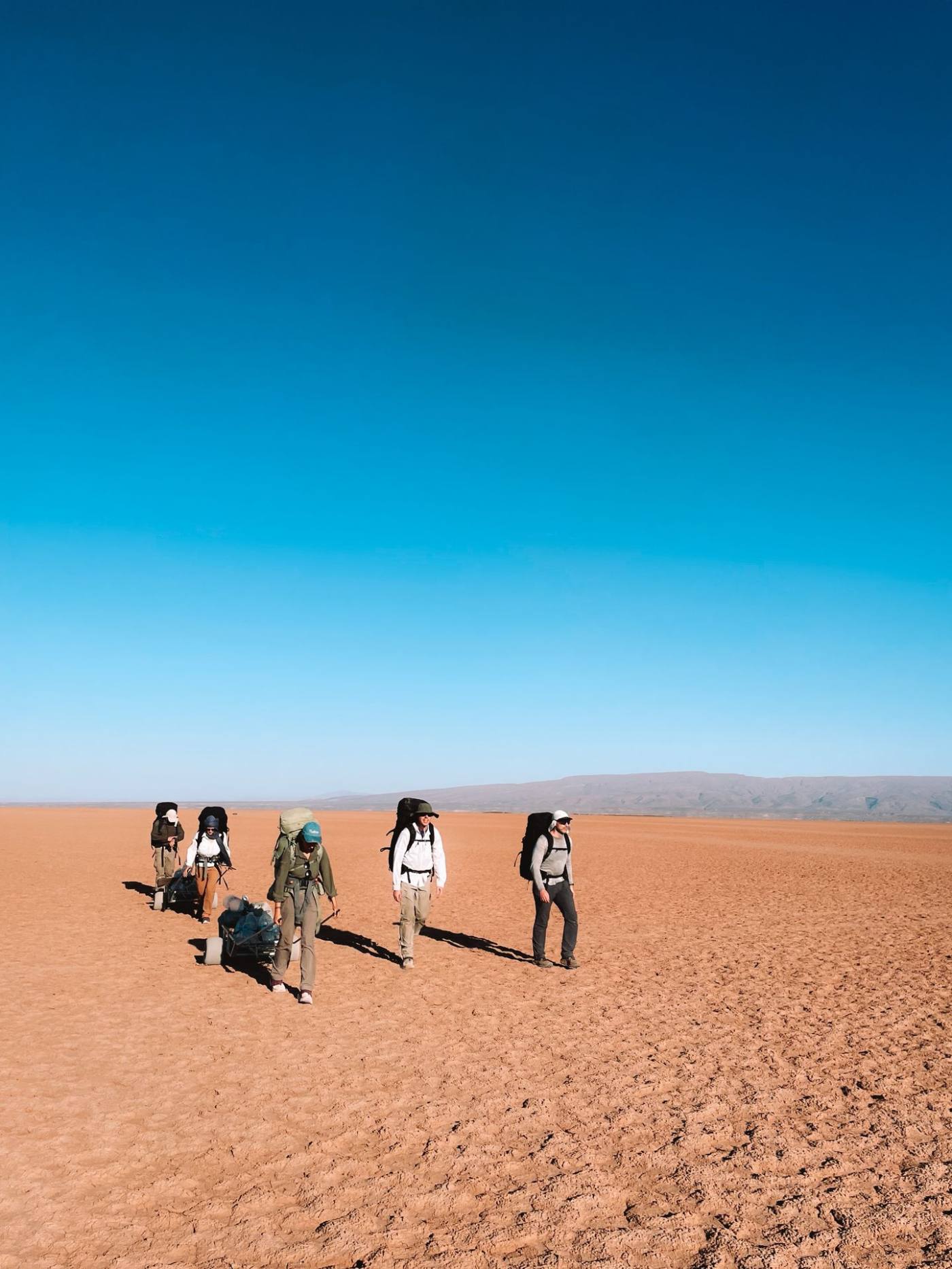 Group on foot through open terrain during an Element X expedition