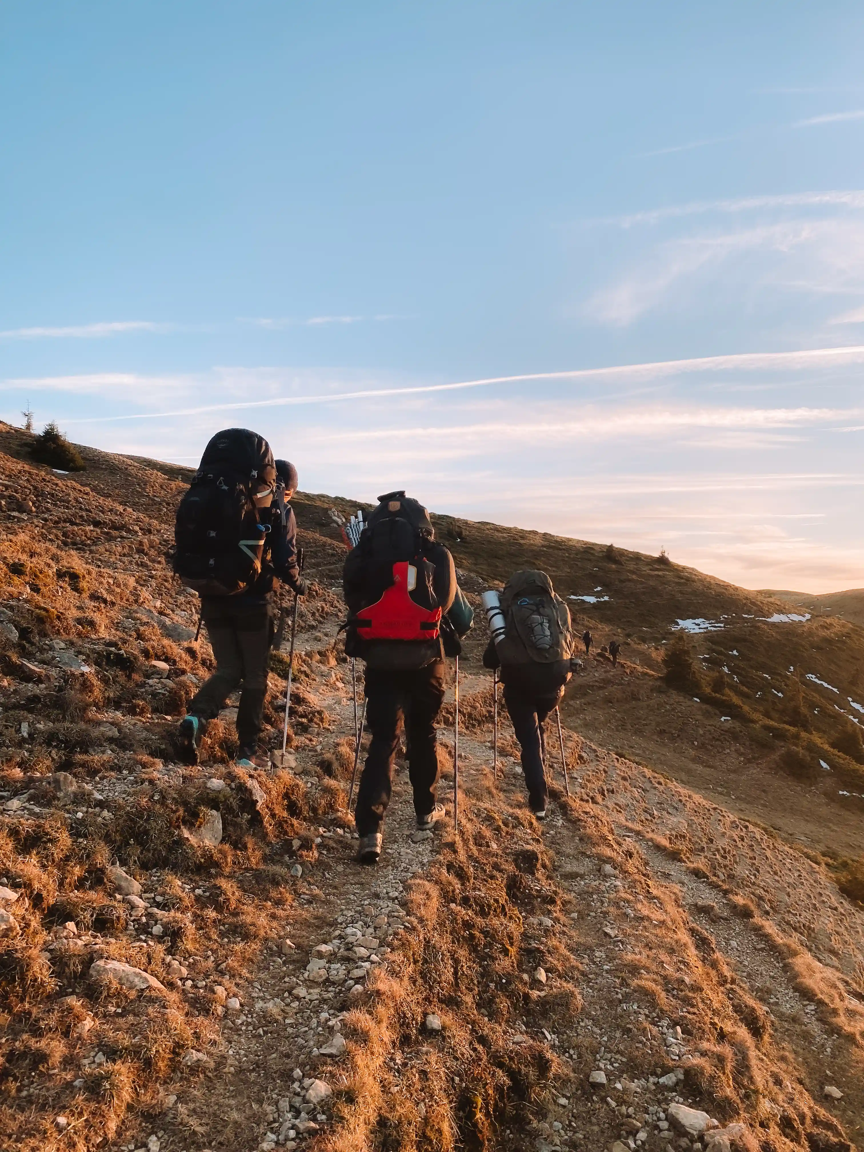 Expedition leaders with full packs heading for the ridge in the Carpathians